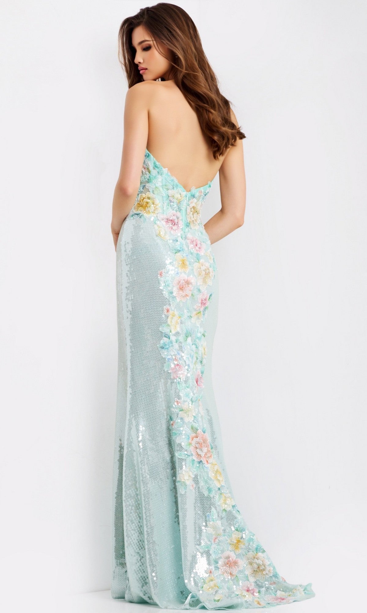 A woman models the Jovani 49627 long prom dress, featuring a light blue strapless floral-embroidered corset, sequined sheath skirt, low back, and floor-length hem against a plain white background.
